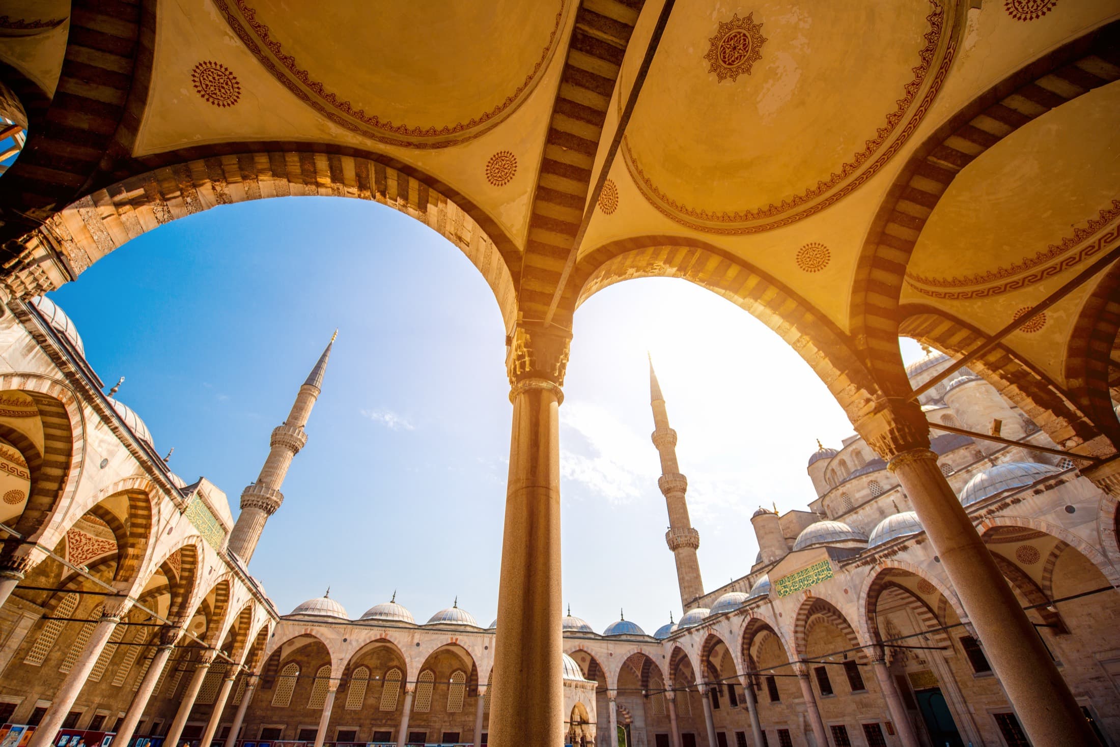 Looking up through the arches of a mosque courtyard