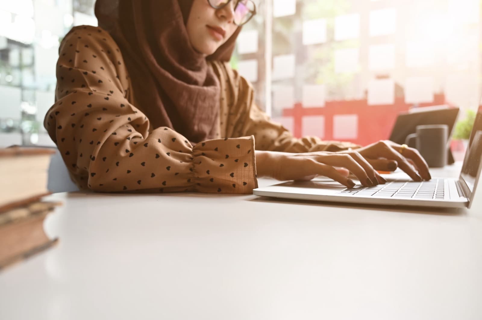 A woman typing on a laptop